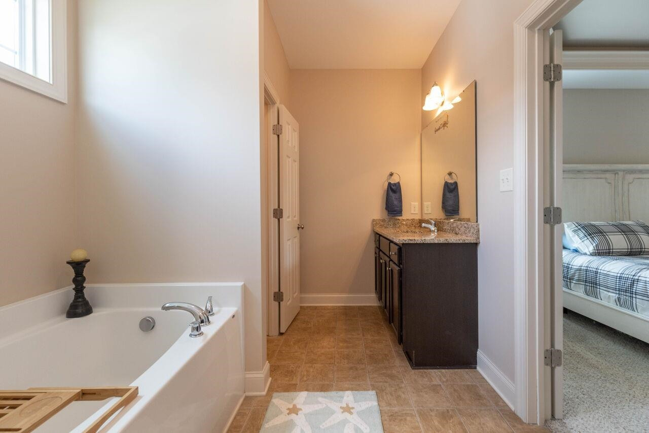 100 Celestial Drive Garner, NC 27529 - Photo 17 of 31 a bathroom with a tub sink and mirror