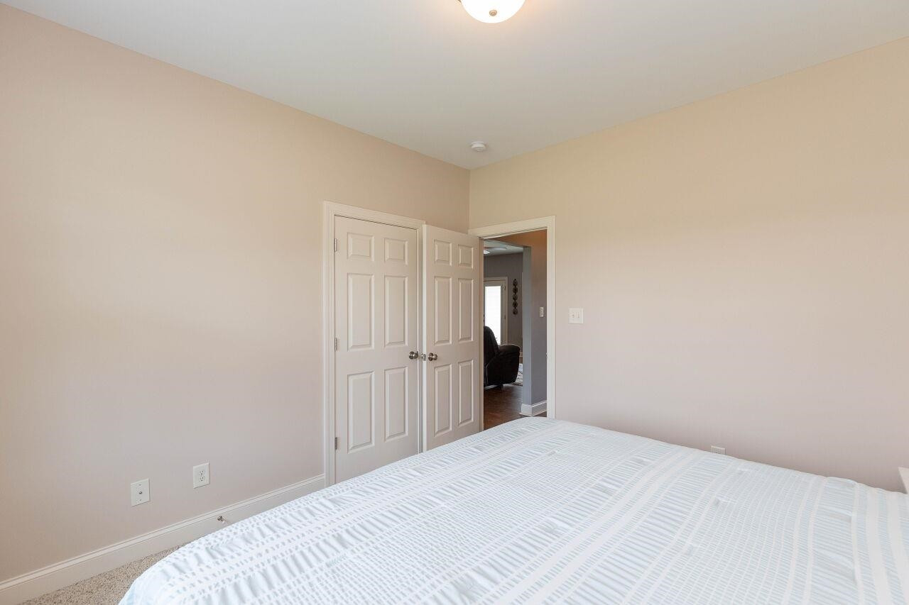 100 Celestial Drive Garner, NC 27529 - Photo 19 of 31 a bedroom with a bed and a bathroom