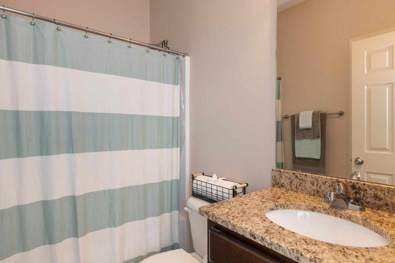 100 Celestial Drive Garner, NC 27529 - Photo 20 of 31 a bathroom with a granite countertop sink and a mirror