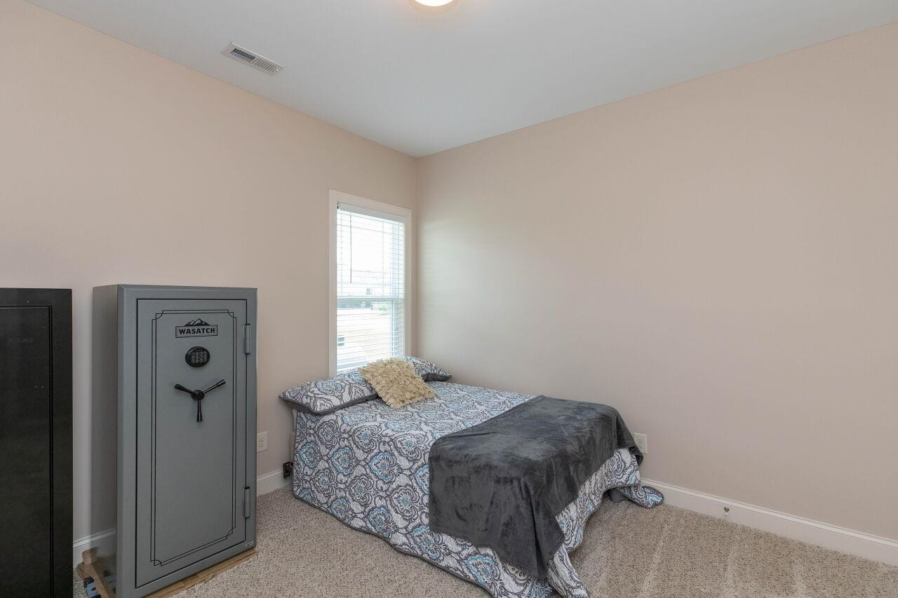 100 Celestial Drive Garner, NC 27529 - Photo 21 of 31 a bedroom with a bed and a window