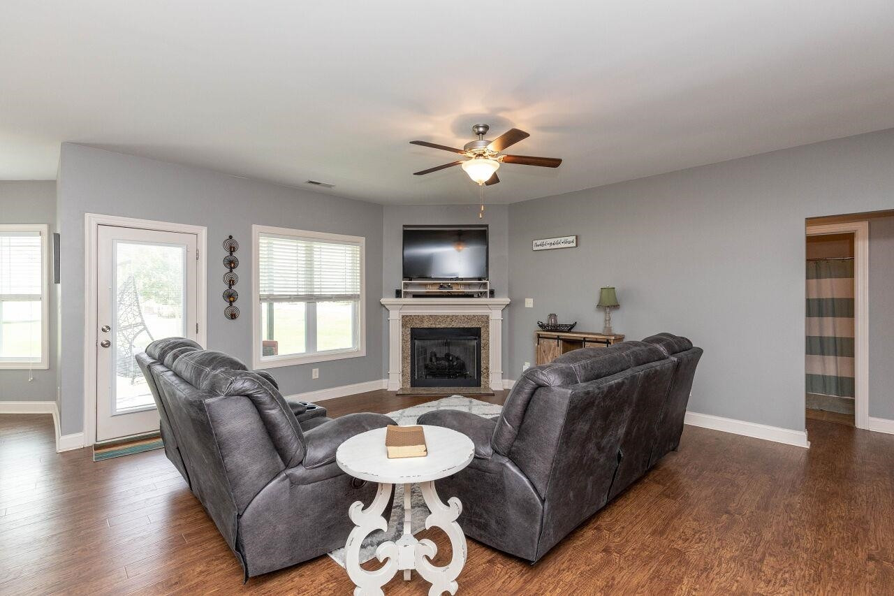 100 Celestial Drive Garner, NC 27529 - Photo 8 of 31 a living room with furniture a fireplace and a flat screen tv