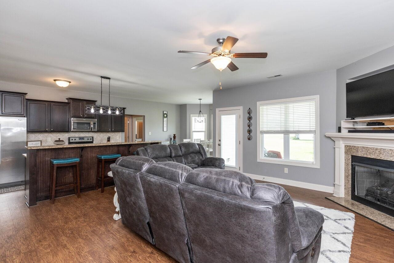 100 Celestial Drive Garner, NC 27529 - Photo 9 of 31 a living room with furniture a fireplace and a flat screen tv