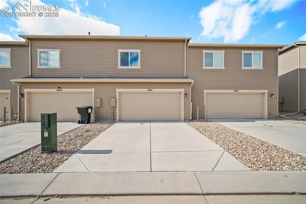 a front view of a house with a garage