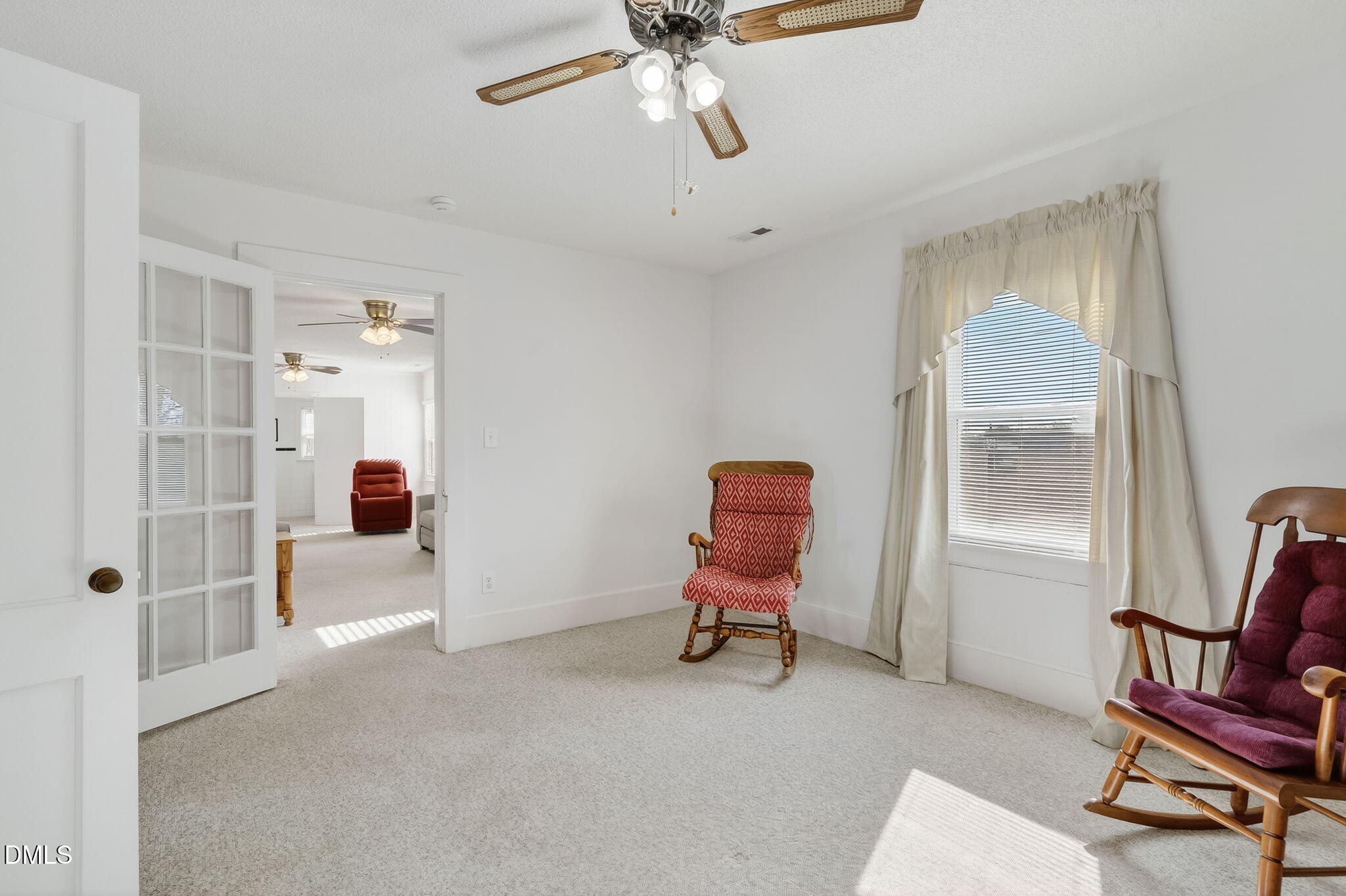 3084 Tarheel Road Benson, NC 27504 - Photo 14 of 37 a view of a livingroom with furniture and a ceiling fan