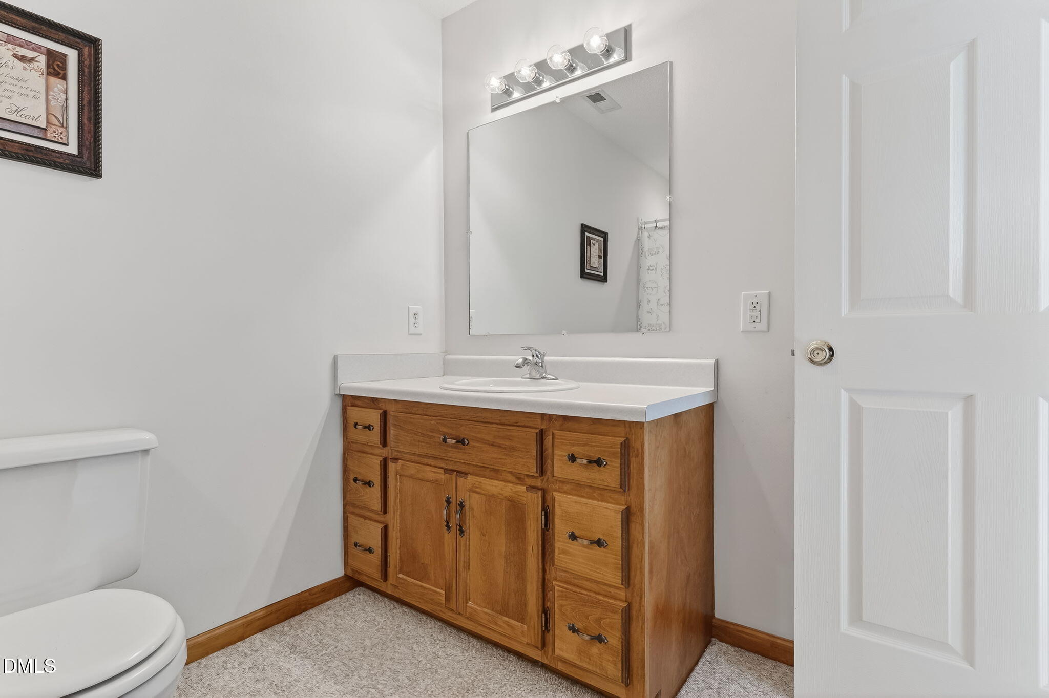 3084 Tarheel Road Benson, NC 27504 - Photo 16 of 37 a spacious bathroom with a sink a toilet and a mirror