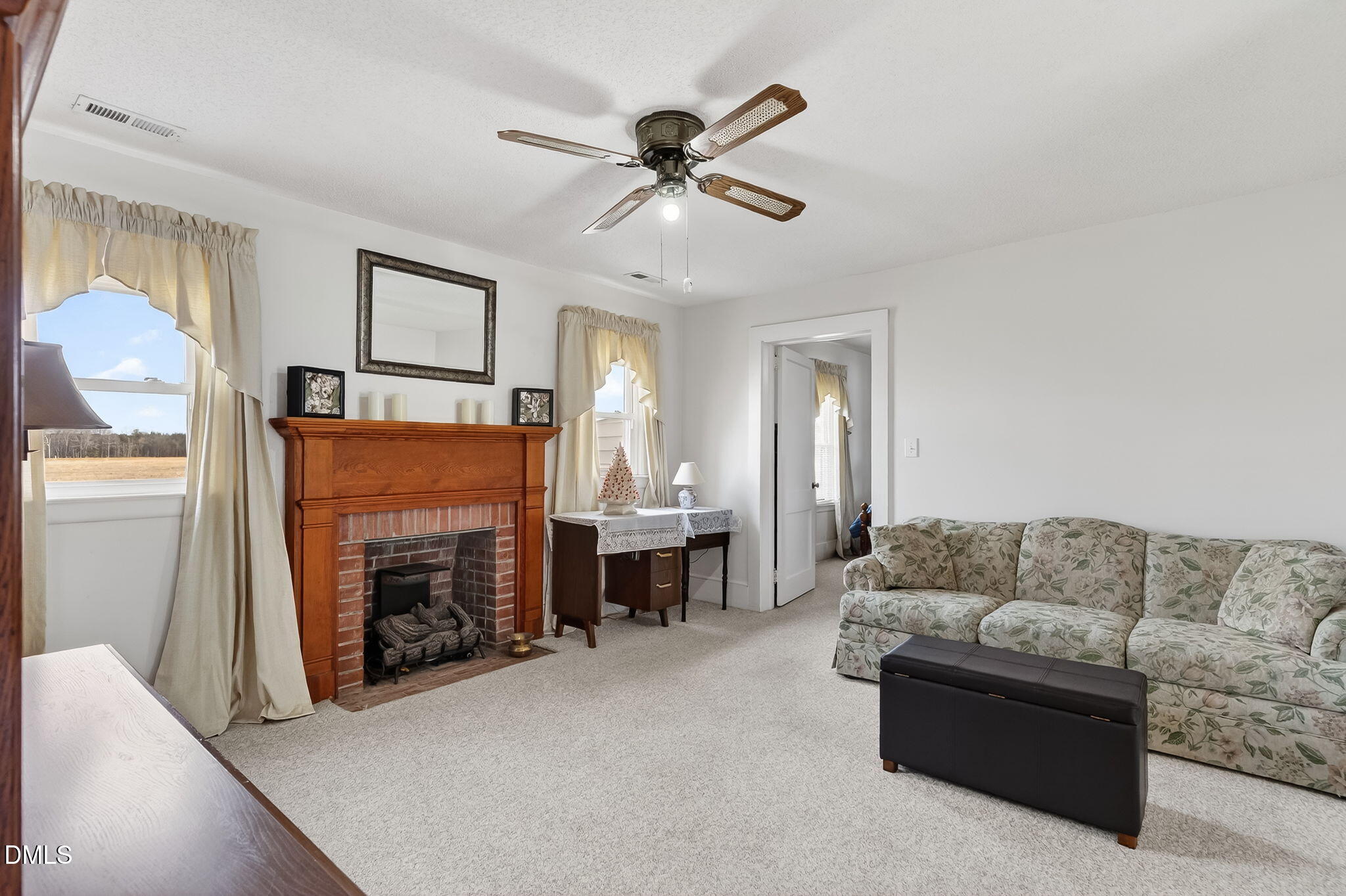 3084 Tarheel Road Benson, NC 27504 - Photo 17 of 37 a living room with furniture and a fireplace