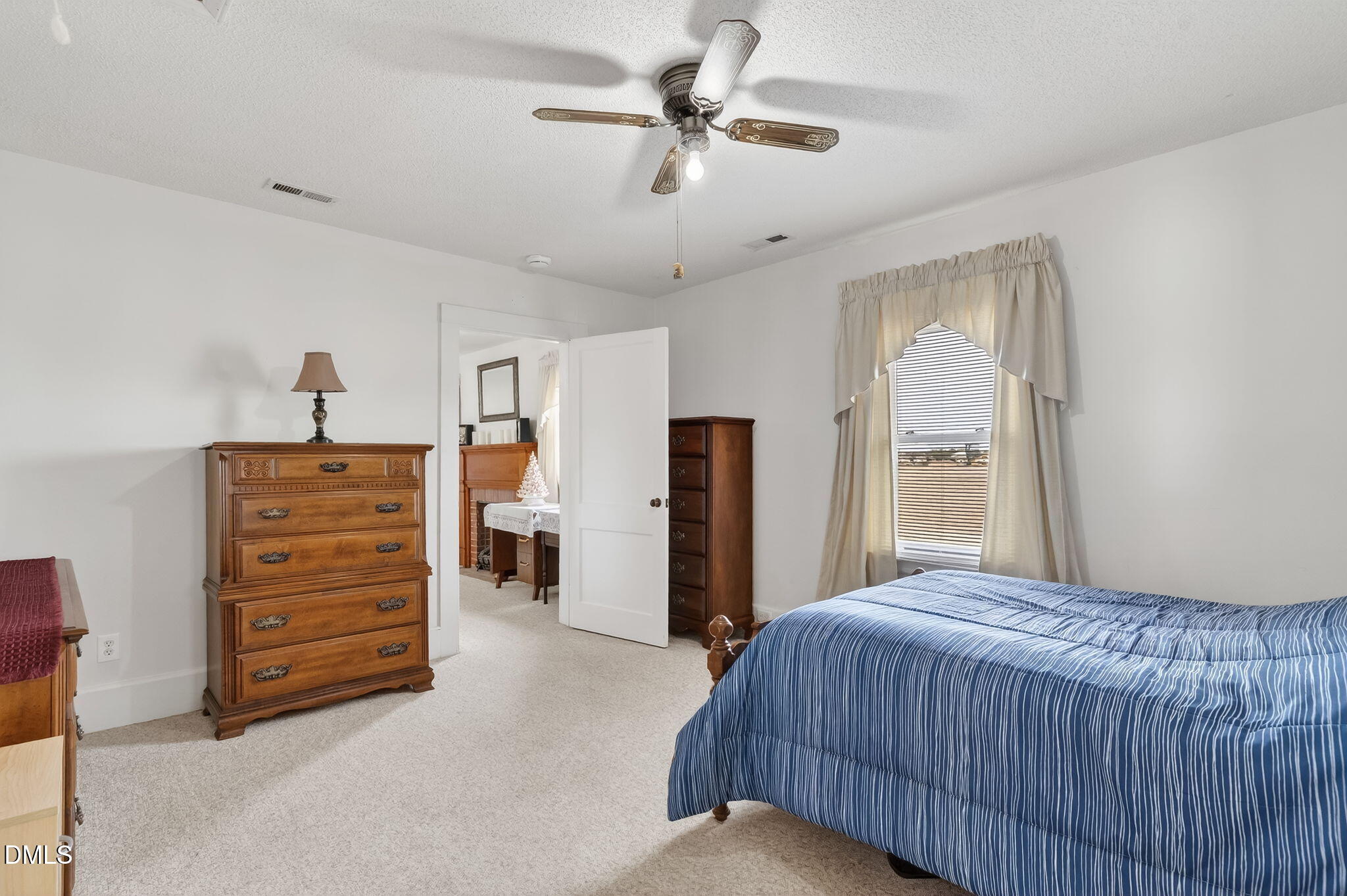3084 Tarheel Road Benson, NC 27504 - Photo 20 of 37 a bedroom with a bed and a cabinet