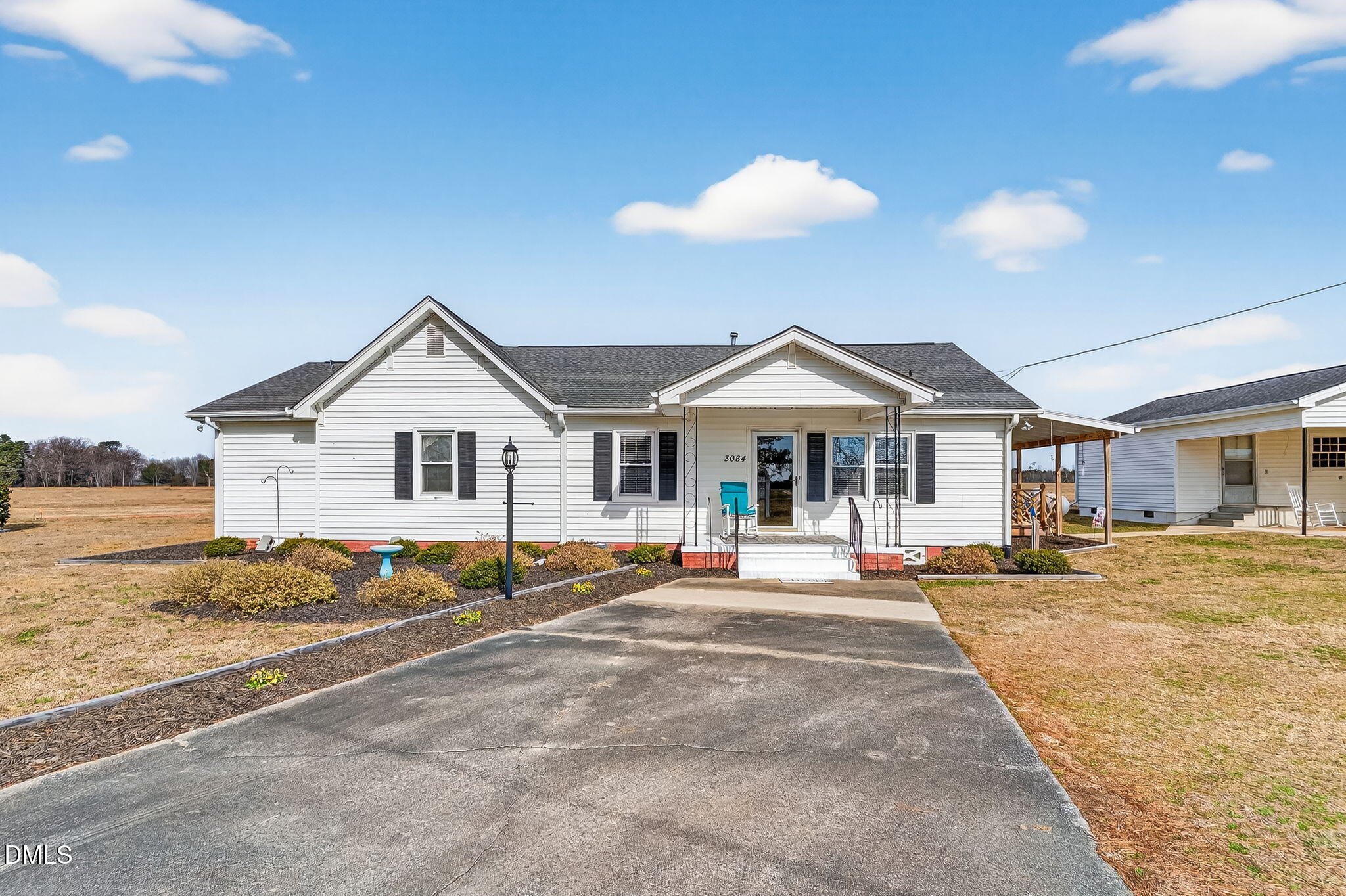 3084 Tarheel Road Benson, NC 27504 - Photo 2 of 37 a view of a white house with a yard patio and fire pit