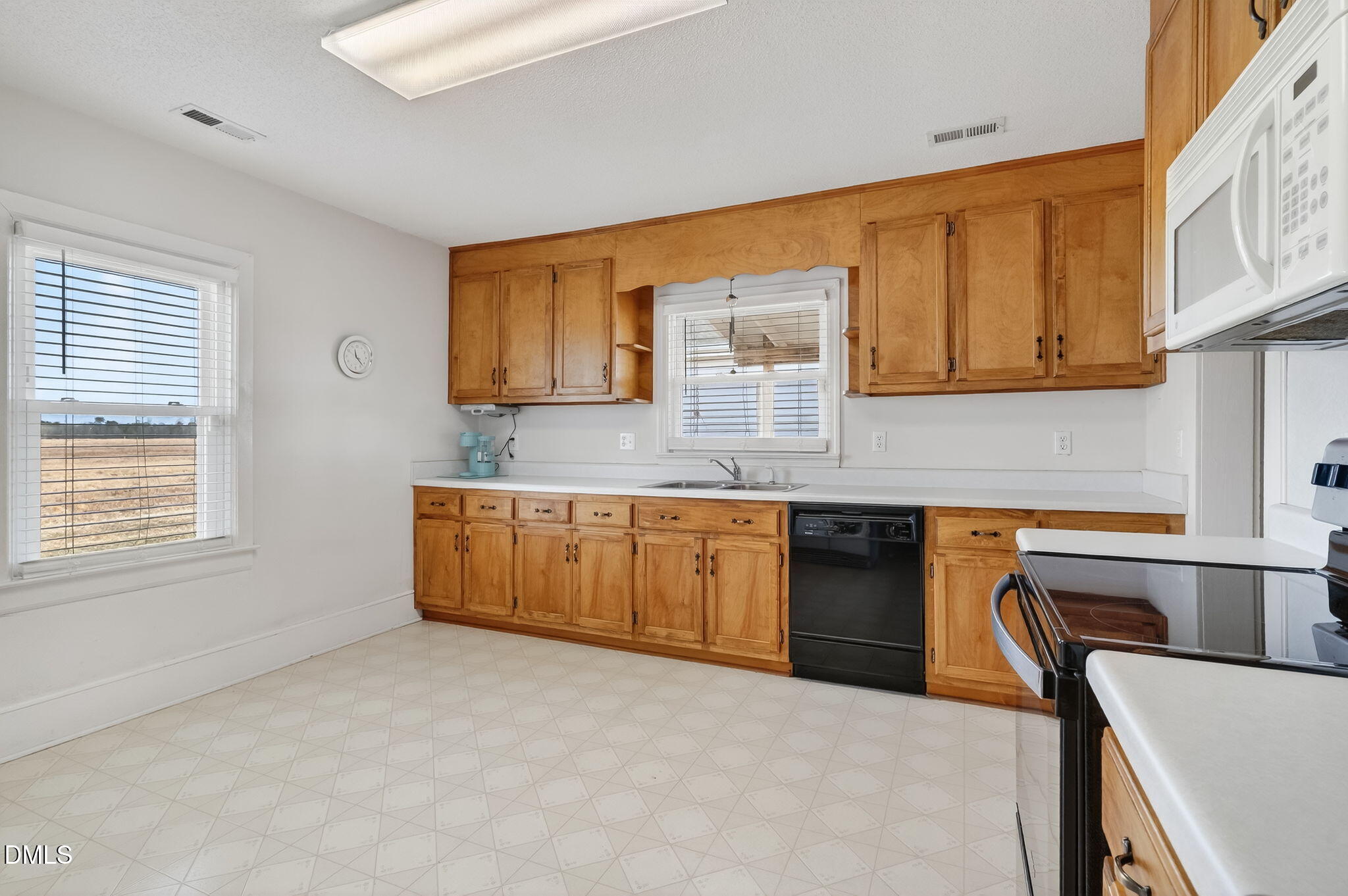 3084 Tarheel Road Benson, NC 27504 - Photo 22 of 37 a kitchen with granite countertop a sink cabinets and stainless steel appliances