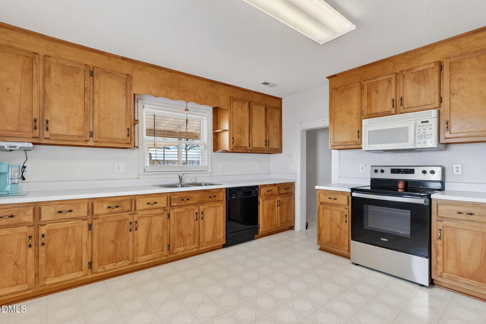 3084 Tarheel Road Benson, NC 27504 - Photo 23 of 37 a kitchen with stainless steel appliances granite countertop a stove sink and cabinets