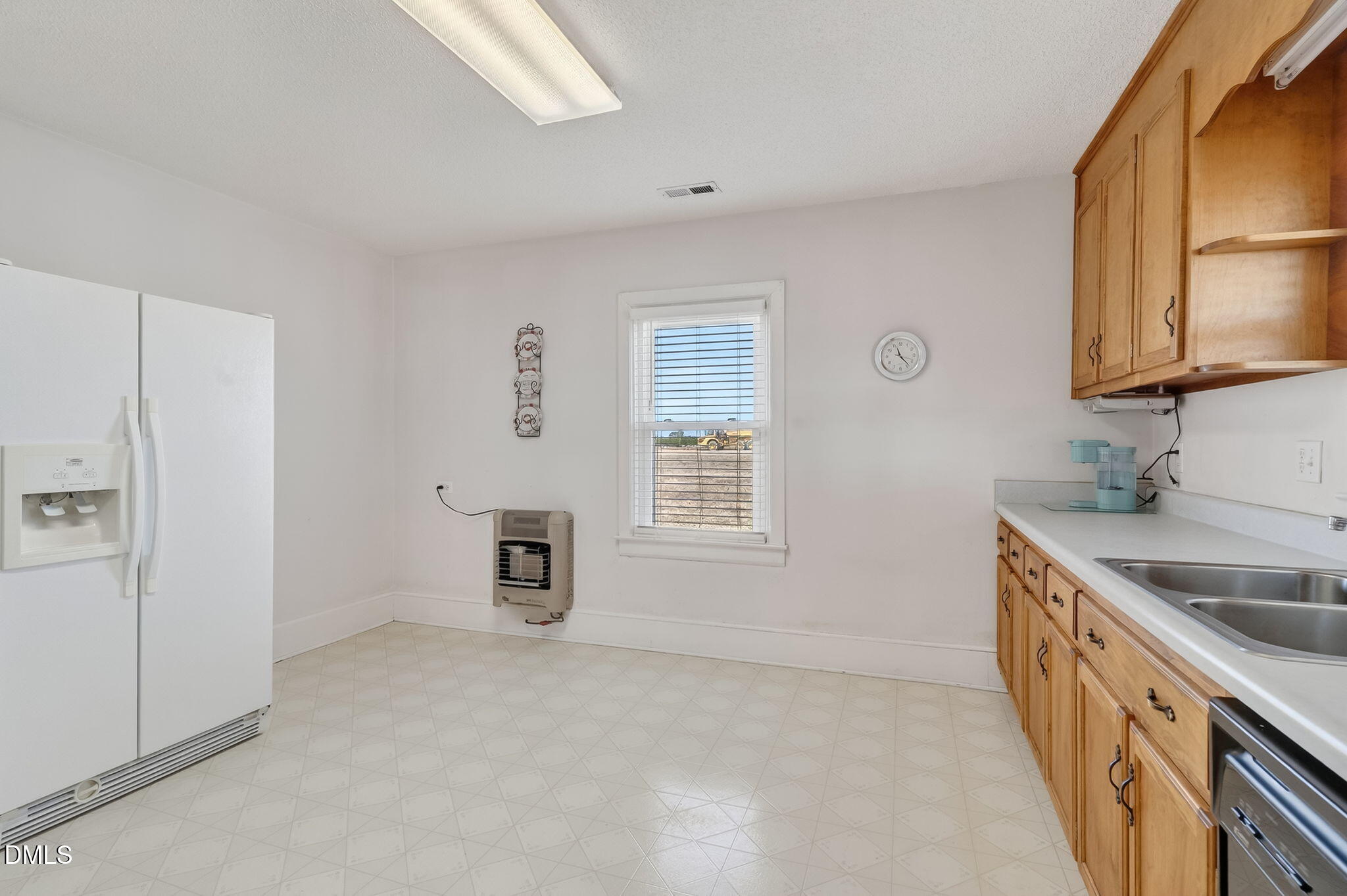 3084 Tarheel Road Benson, NC 27504 - Photo 24 of 37 a kitchen with stainless steel appliances granite countertop a sink and a stove top oven