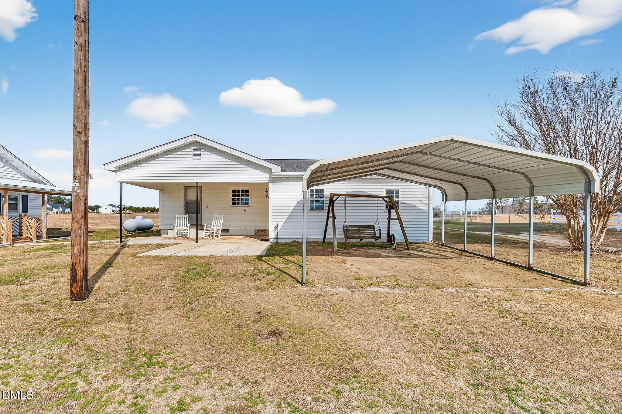 3084 Tarheel Road Benson, NC 27504 - Photo 30 of 37 a view of patio with a table and chairs under an umbrella