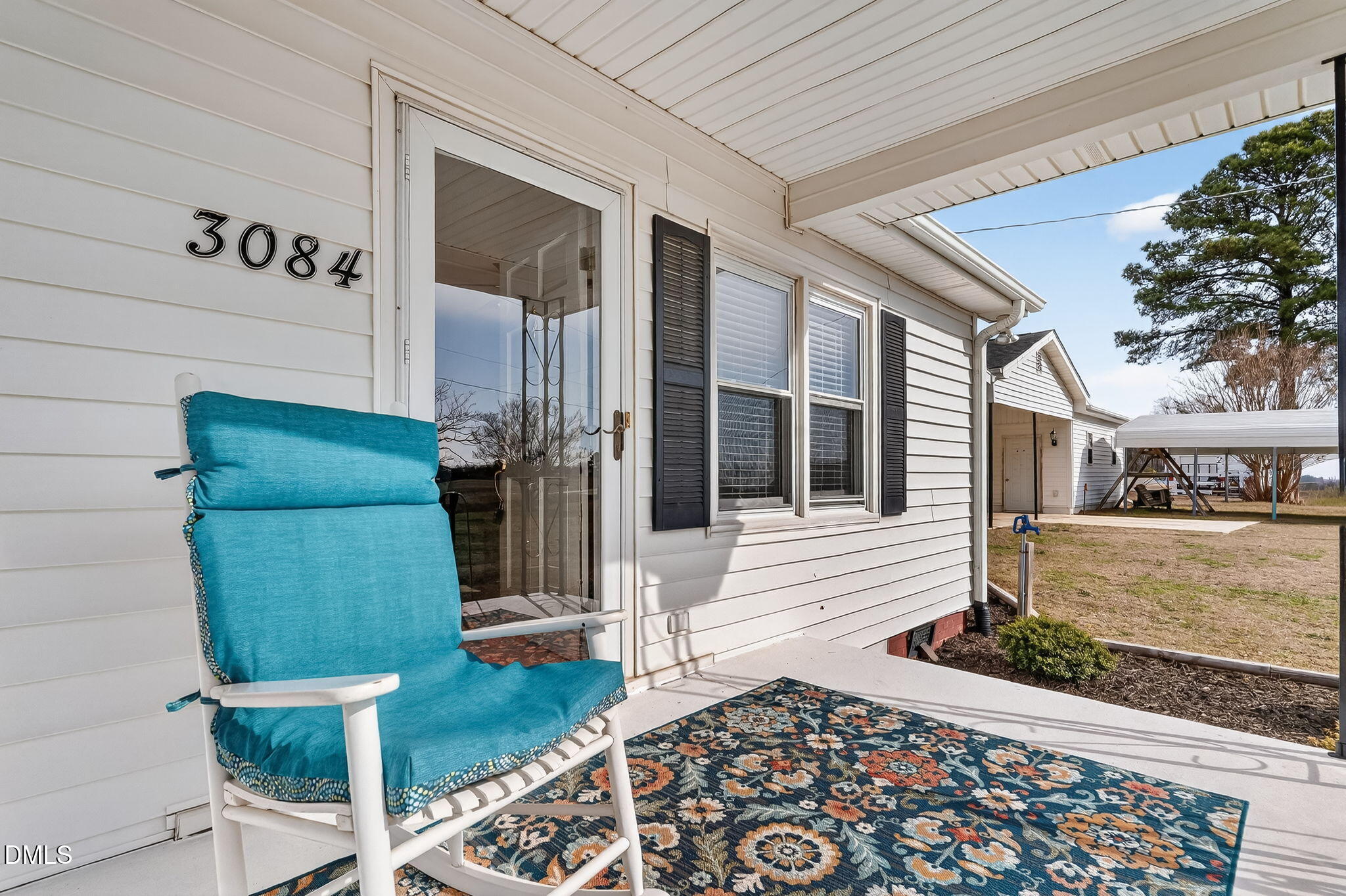 3084 Tarheel Road Benson, NC 27504 - Photo 6 of 37 a view of a door and chair in the patio