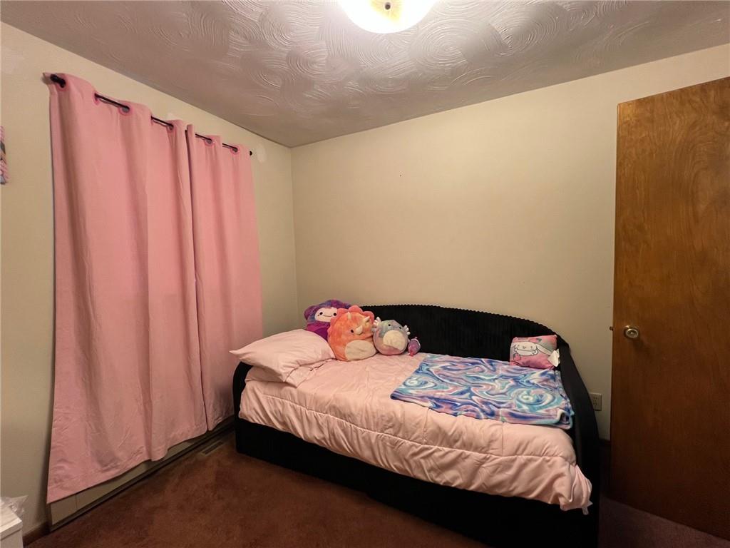 671 York Run Road Smithfield, PA 15478 - Photo 15 of 49 a bedroom with a bed and curtain