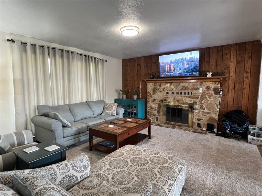 671 York Run Road Smithfield, PA 15478 - Photo 4 of 49 a living room with furniture a fireplace and a flat screen tv