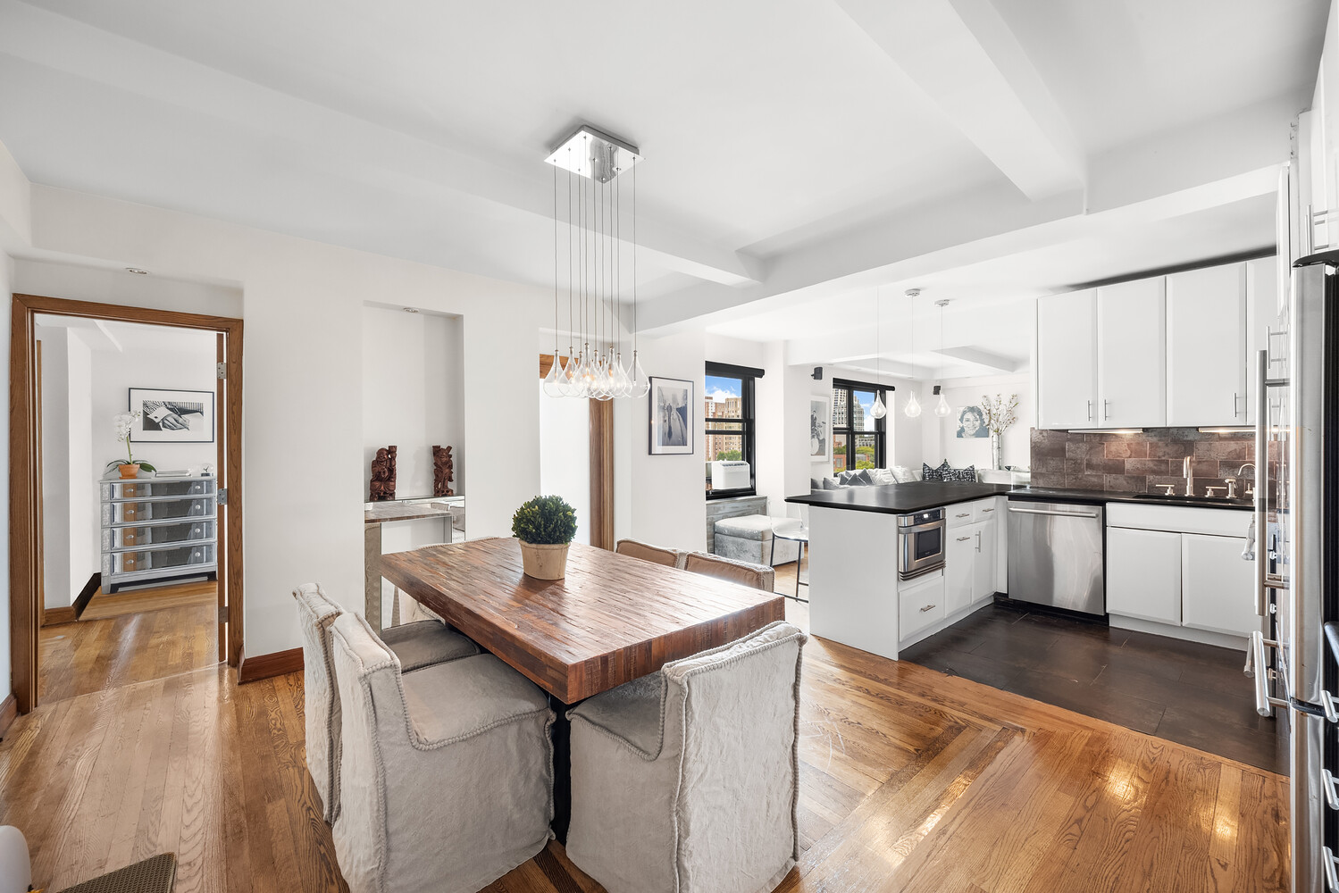 a kitchen with white cabinets and counter space
