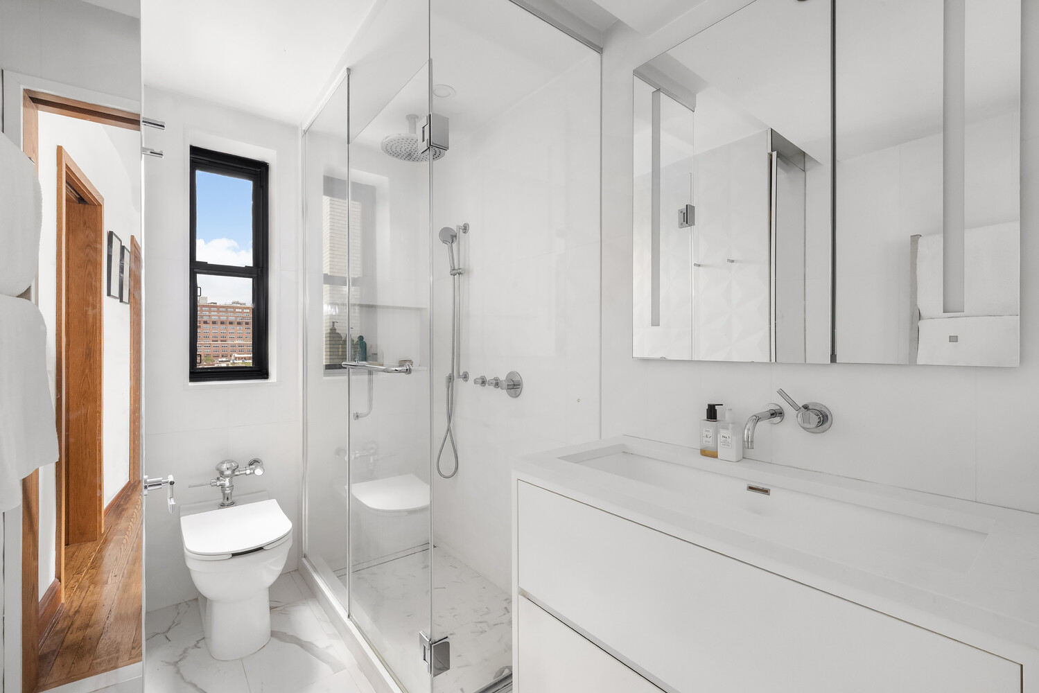 300 West 23rd Street, Unit 11M Manhattan, NY 10011 - Photo 2 of 9 a bathroom with a sink a toilet and shower