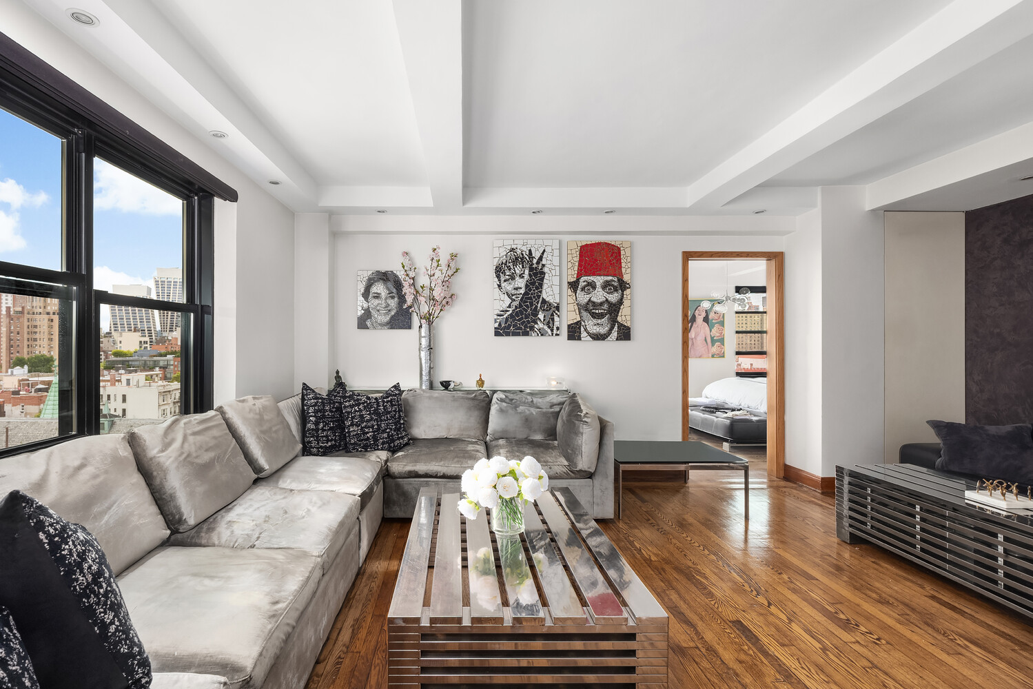 300 West 23rd Street, Unit 11M Manhattan, NY 10011 - Photo 4 of 9 a living room with furniture and a flat screen tv