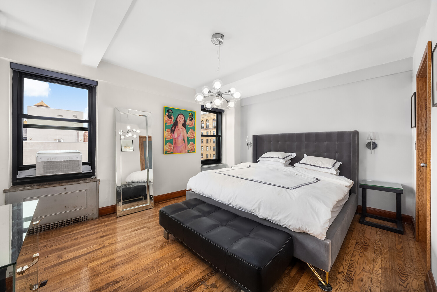 300 West 23rd Street, Unit 11M Manhattan, NY 10011 - Photo 6 of 9 a spacious bedroom with a bed a window and dresser