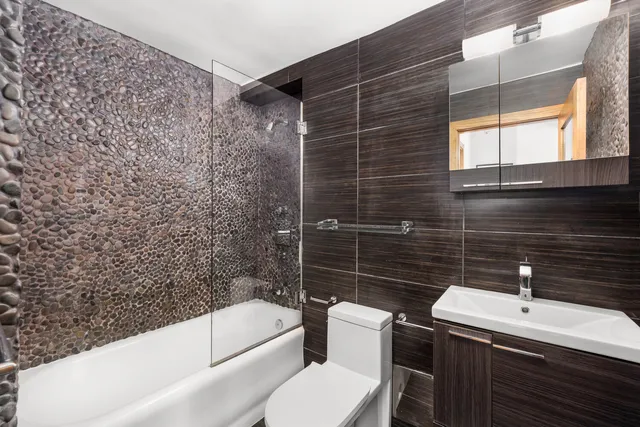 a bathroom with a sink toilet and shower