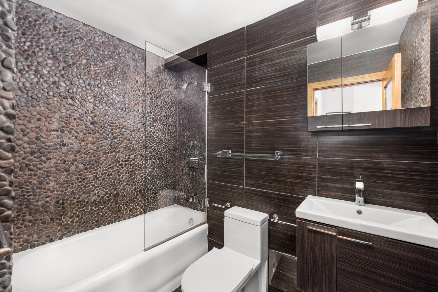 300 West 23rd Street, Unit 11M Manhattan, NY 10011 - Photo 9 of 9 a bathroom with a sink toilet and shower