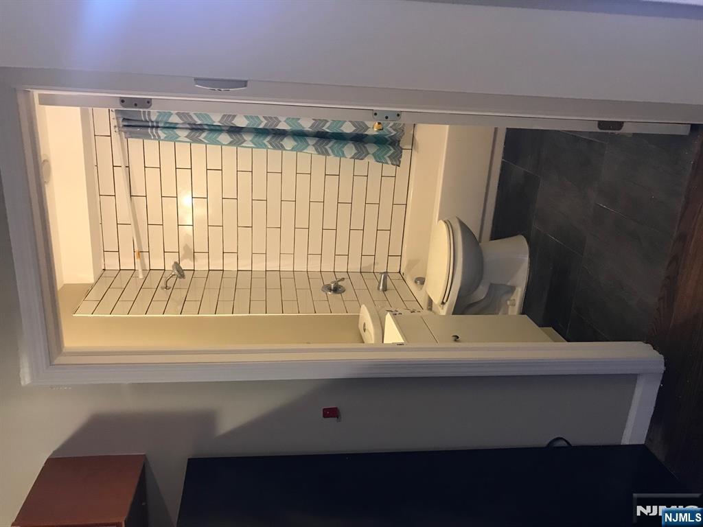 500 Fulton Street, Unit 1 Elizabeth, NJ 07206 - Photo 4 of 4 a bathroom with a sink a toilet and shower