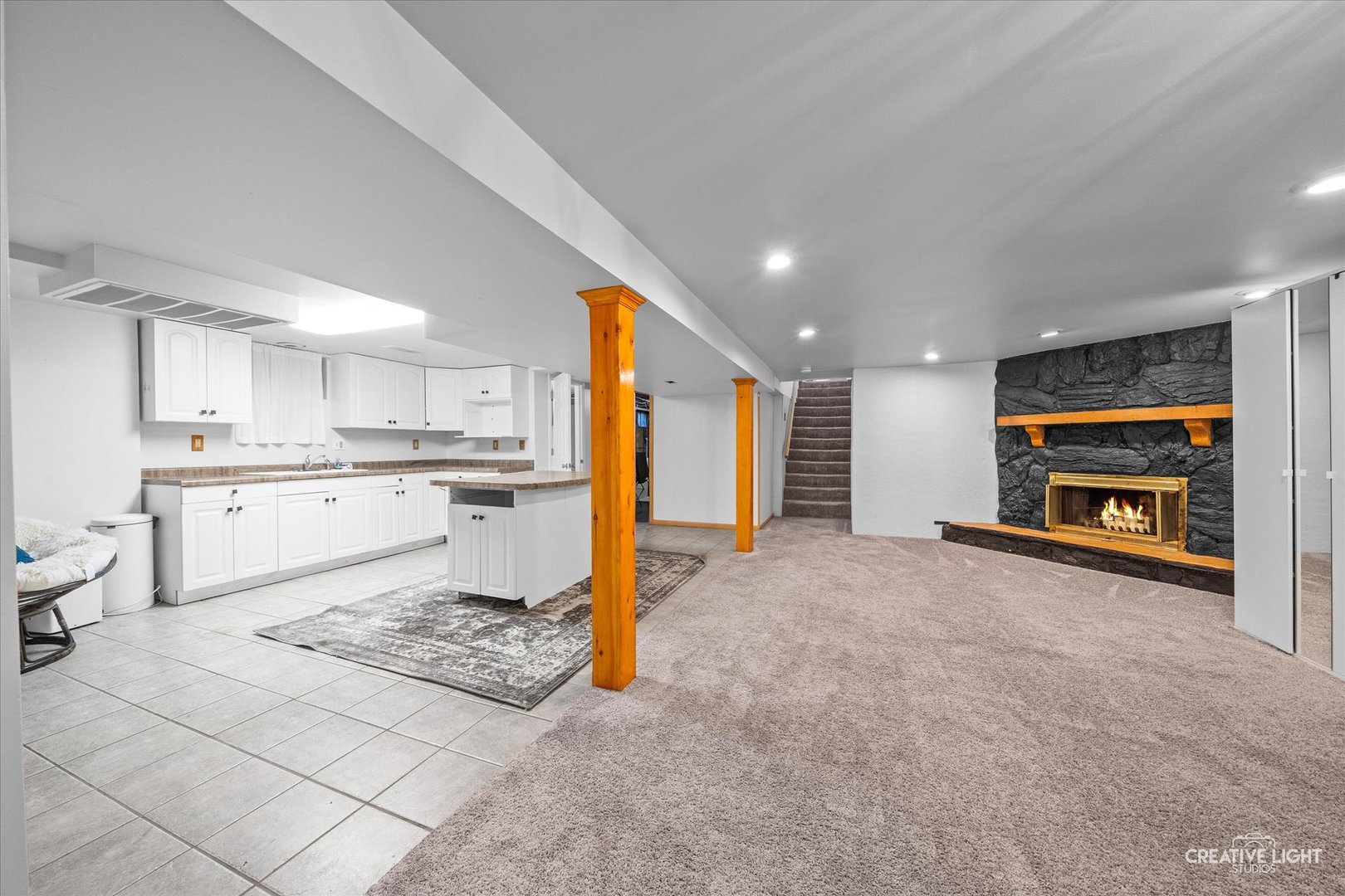 92 Neil Road Sugar Grove, IL 60554 - Photo 19 of 34 a living room with stainless steel appliances furniture a rug and a kitchen view
