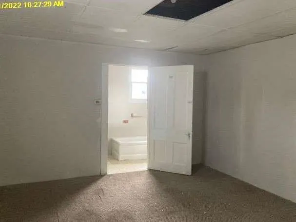 a white toilet sitting next to a bath tub