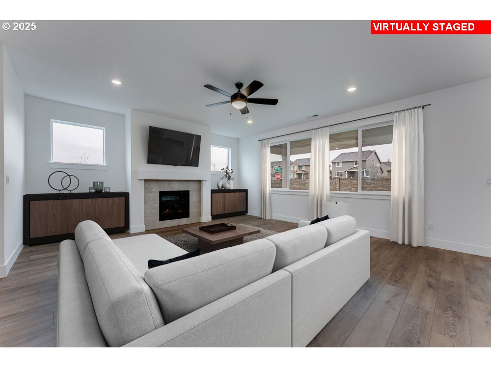 1324 East Canto Newberg, OR 97132 - Photo 2 of 10 a living room with furniture a fireplace and a flat screen tv