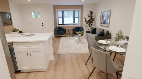 a living room with furniture a dining table and wooden floor