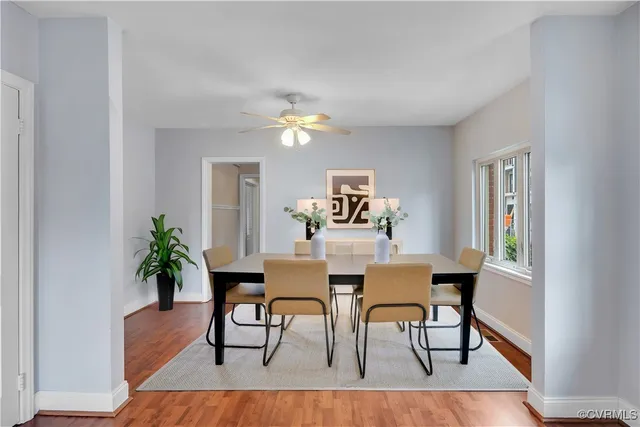 a view of a dining room with furniture and wooden floor