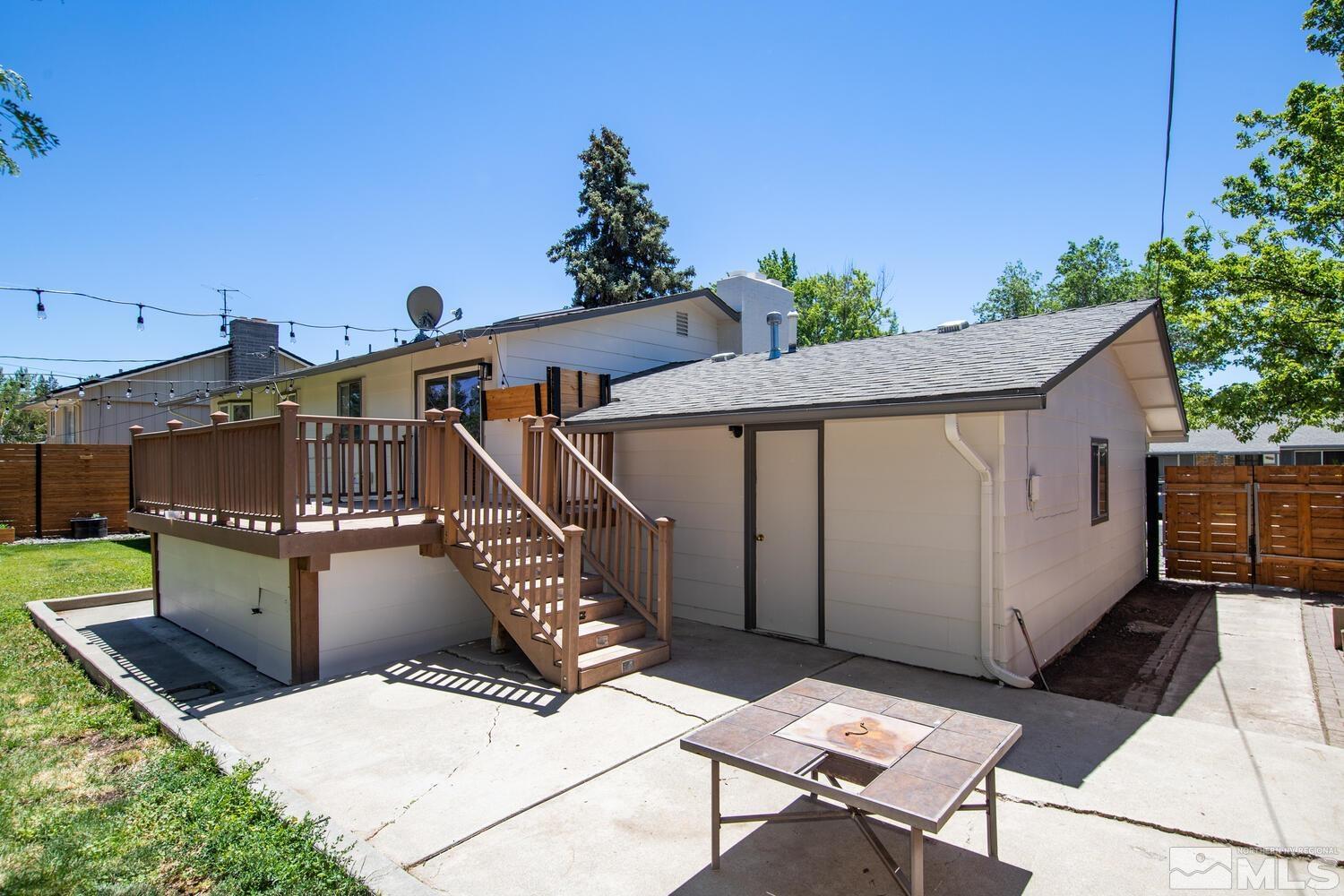 895 Grandview Avenue Reno, NV 89503 - Photo 36 of 39 a view of a roof deck with table and chairs with wooden fence