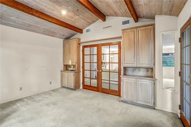a view of an empty room with a kitchen