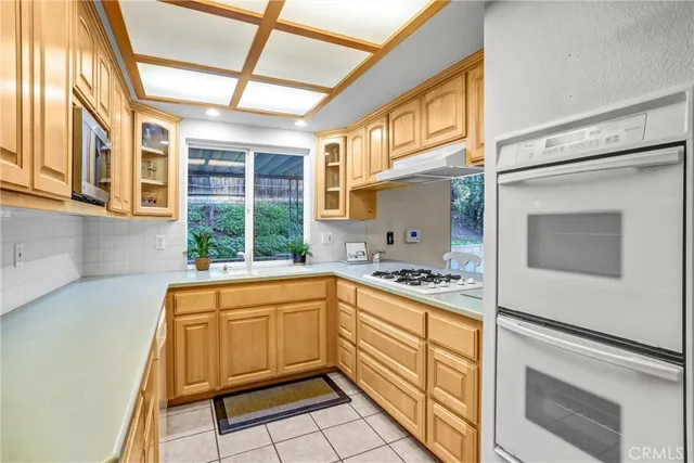a kitchen with a stove a sink and a refrigerator