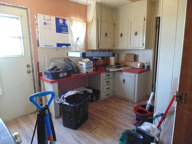 a kitchen with stainless steel appliances granite countertop a refrigerator and a stove