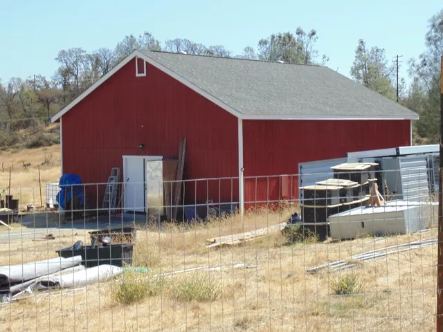 a backyard of a house with barbeque oven