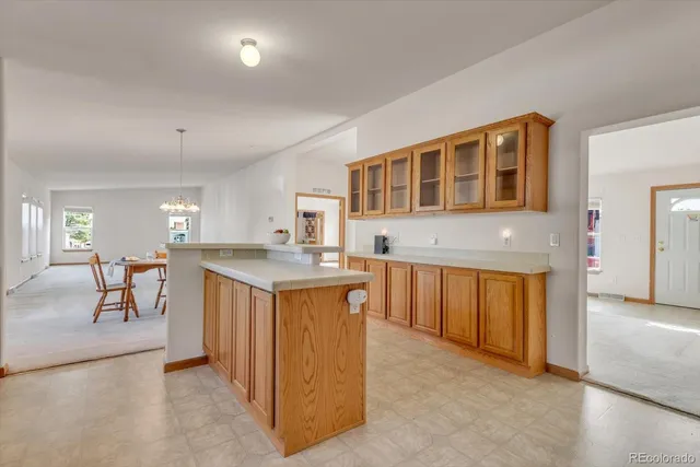 a living room with stainless steel appliances granite countertop sink stove and cabinets