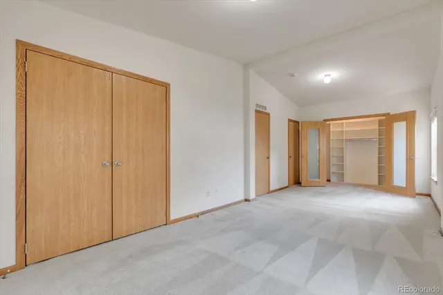 an empty room with closet area