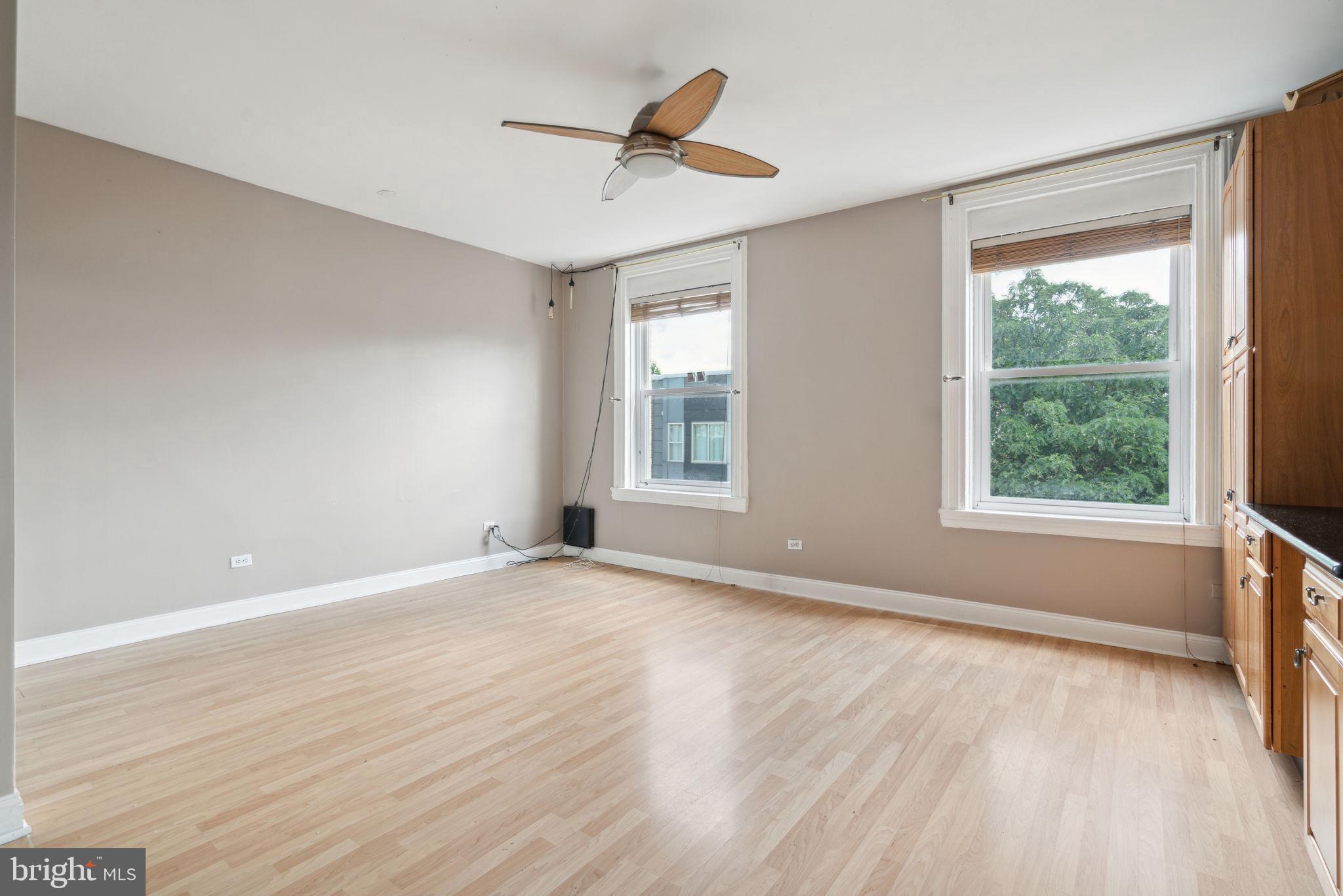 1936 North 7th Street, Unit 3 Philadelphia, PA 19122 - Photo 11 of 29 a view of an empty room with a window and wooden floor