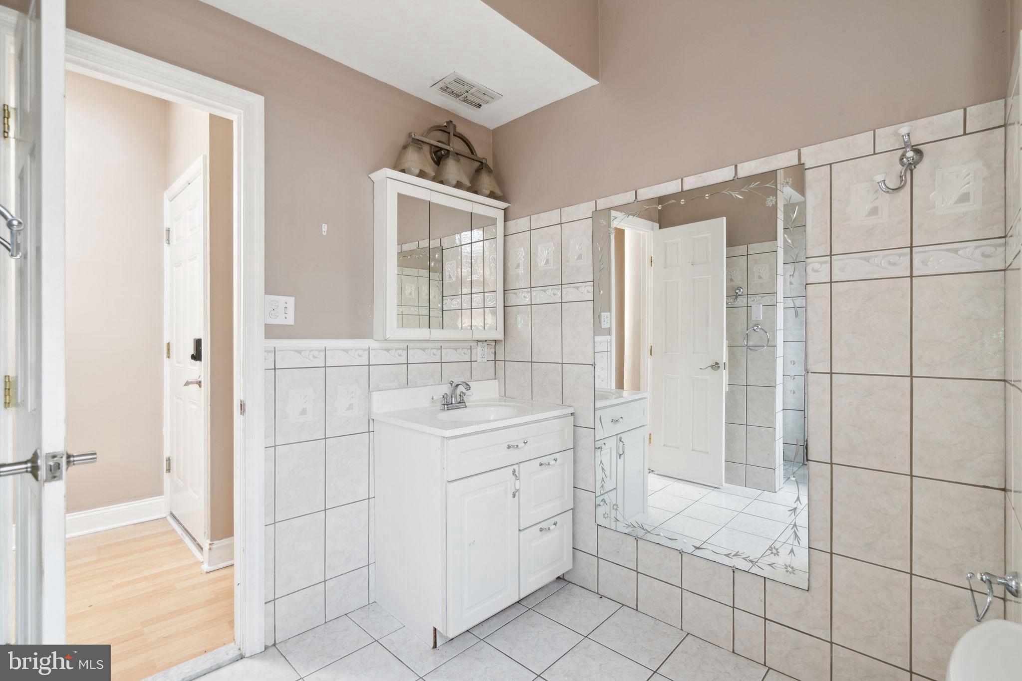 1936 North 7th Street, Unit 3 Philadelphia, PA 19122 - Photo 16 of 29 a bathroom with a shower sink and mirror