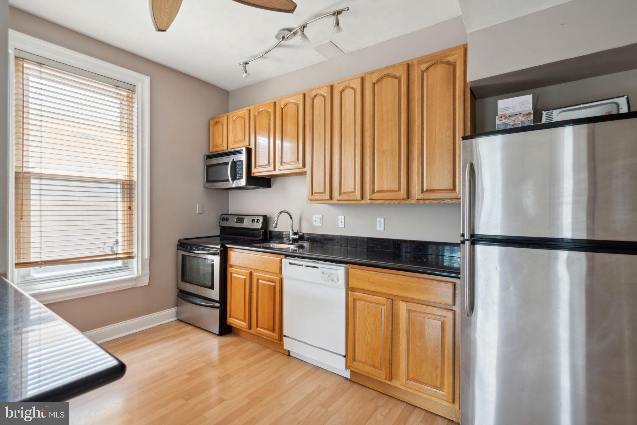 1936 North 7th Street, Unit 3 Philadelphia, PA 19122 - Photo 5 of 29 a kitchen with a refrigerator a sink and cabinets