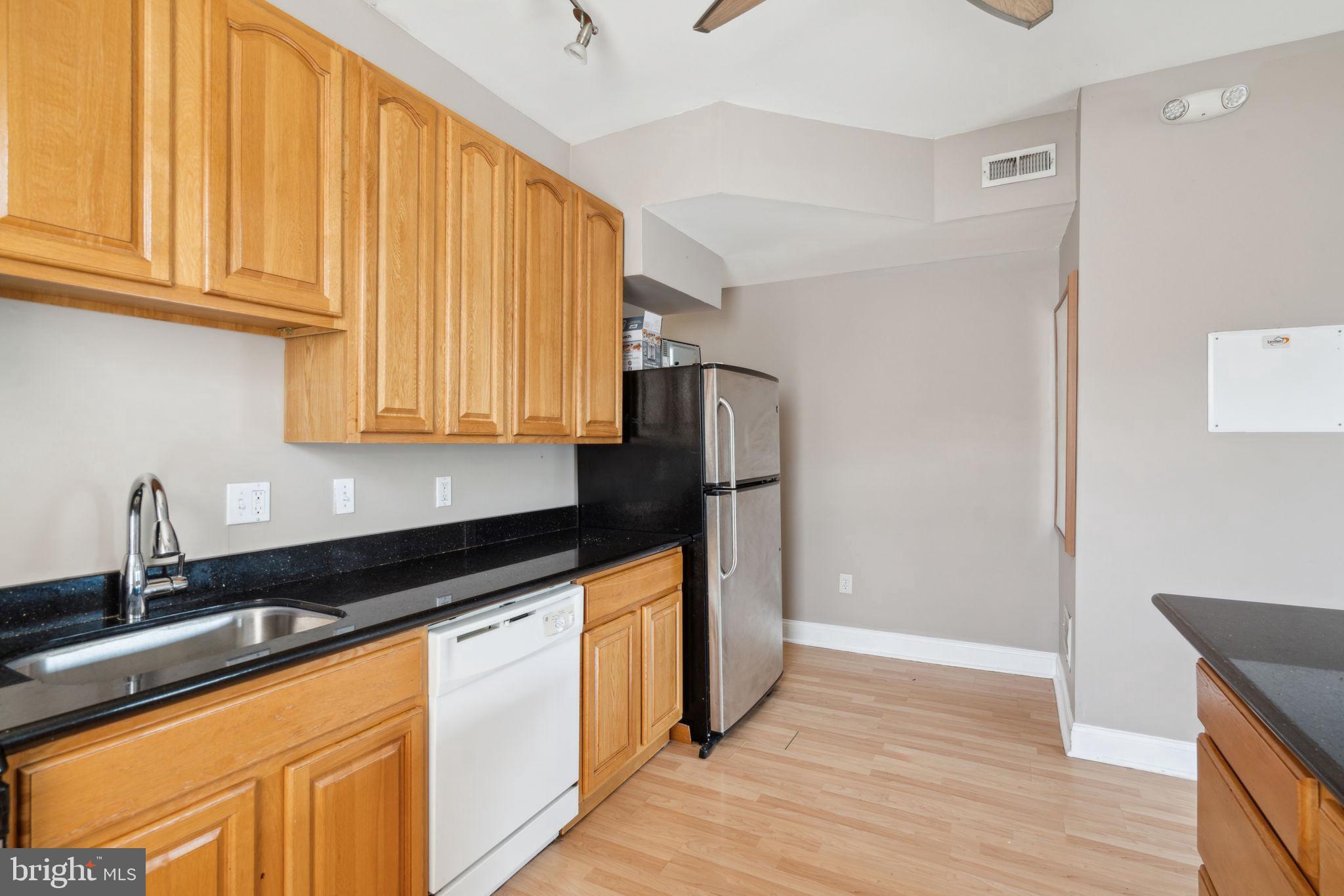 1936 North 7th Street, Unit 3 Philadelphia, PA 19122 - Photo 8 of 29 a kitchen with stainless steel appliances granite countertop a refrigerator sink and cabinets