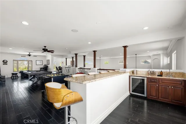 a living room with furniture a ceiling fan and a rug