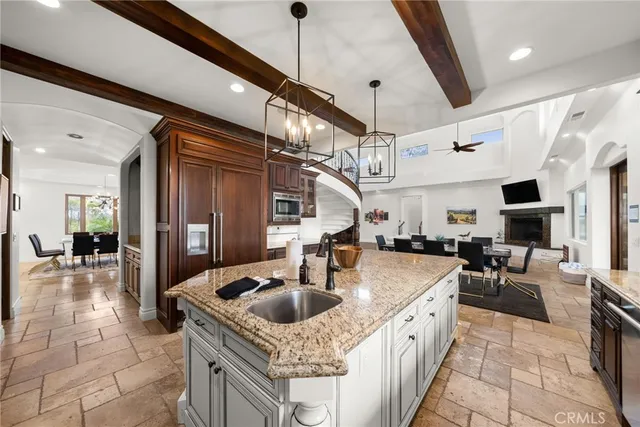 a kitchen with stainless steel appliances granite countertop a sink a stove and a microwave