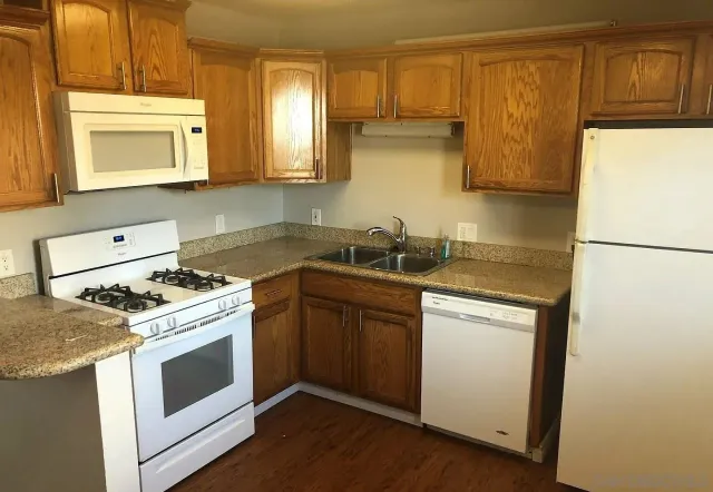 a kitchen with a stove a sink and a refrigerator