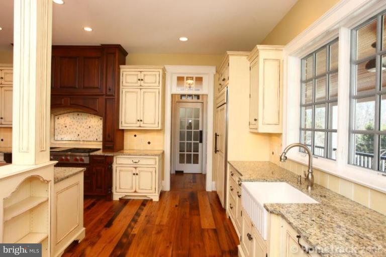1304 Ruxton Road Ruxton, MD 21204 - Photo 12 of 20 a large kitchen with granite countertop a large counter top space a sink stainless steel appliances and cabinets