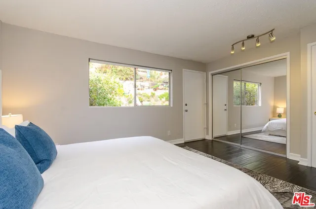 a bedroom with a large bed and a window