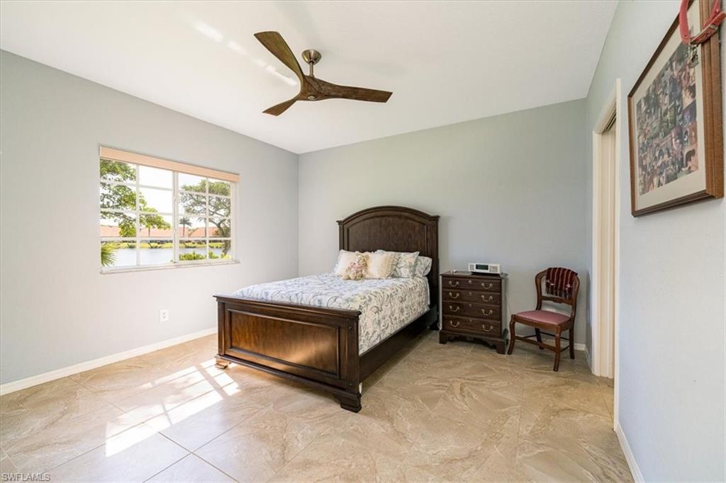 186 Gabriel Circle, Unit 3903 Naples, FL 34104 - Photo 11 of 42 Bedroom featuring ceiling fan and baseboards