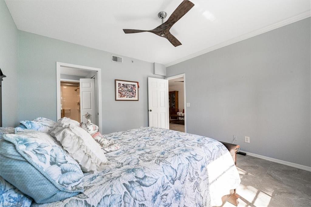 186 Gabriel Circle, Unit 3903 Naples, FL 34104 - Photo 12 of 42 Bedroom with ceiling fan, ensuite bath, and ornamental molding