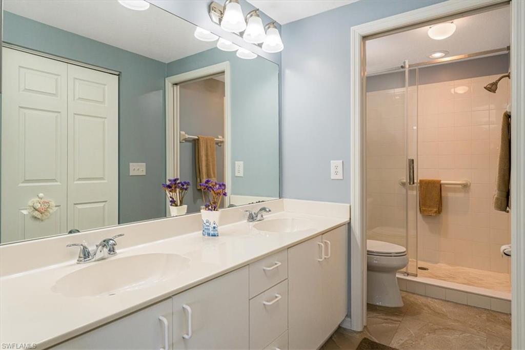 186 Gabriel Circle, Unit 3903 Naples, FL 34104 - Photo 19 of 42 Full bath featuring double vanity and a stall shower